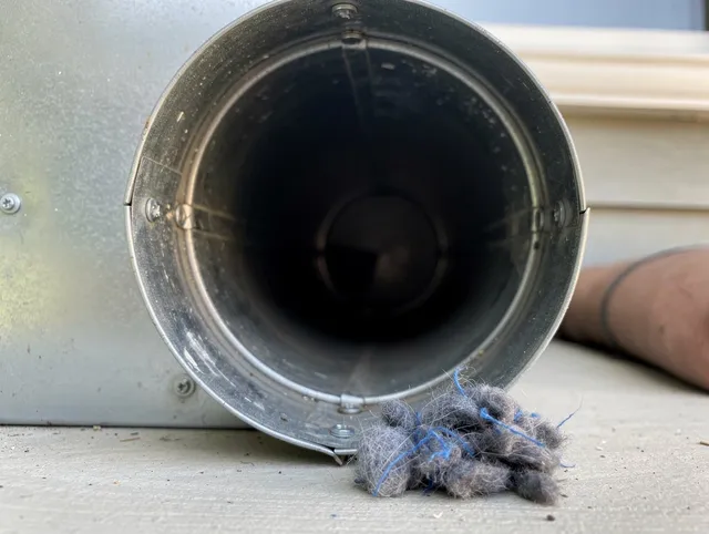 Greenwich Dryer Vent Cleaning technician using specialized equipment to clear severe dryer vent blockage in Greenwich